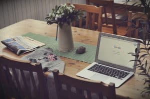 home office with newspaper sweater and laptop with google on it