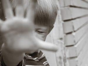 child with outstretched hand saying no