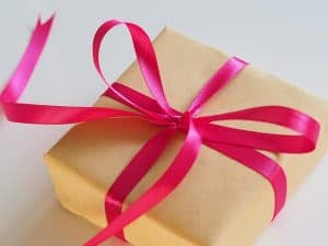 gift wrapped with brown paper and a red bow