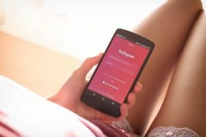 Instagram app shown on phone being held by woman
