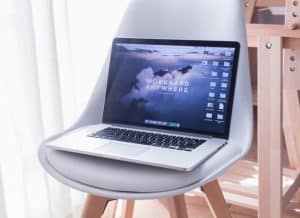 laptop with "work anywhere" as its desktop background