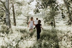 children playing tag in the forest