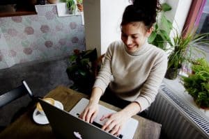woman smiling while using laptop