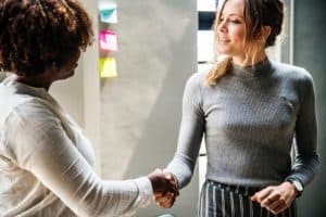 two women shaking hands in an office