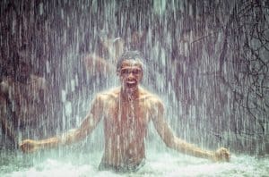 man under a waterfall
