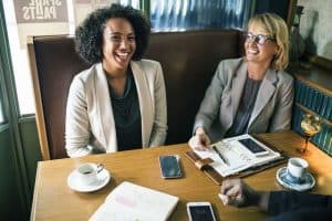 two women in a restaurant talking over work and coffee