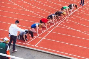 runners on the starting line at a track